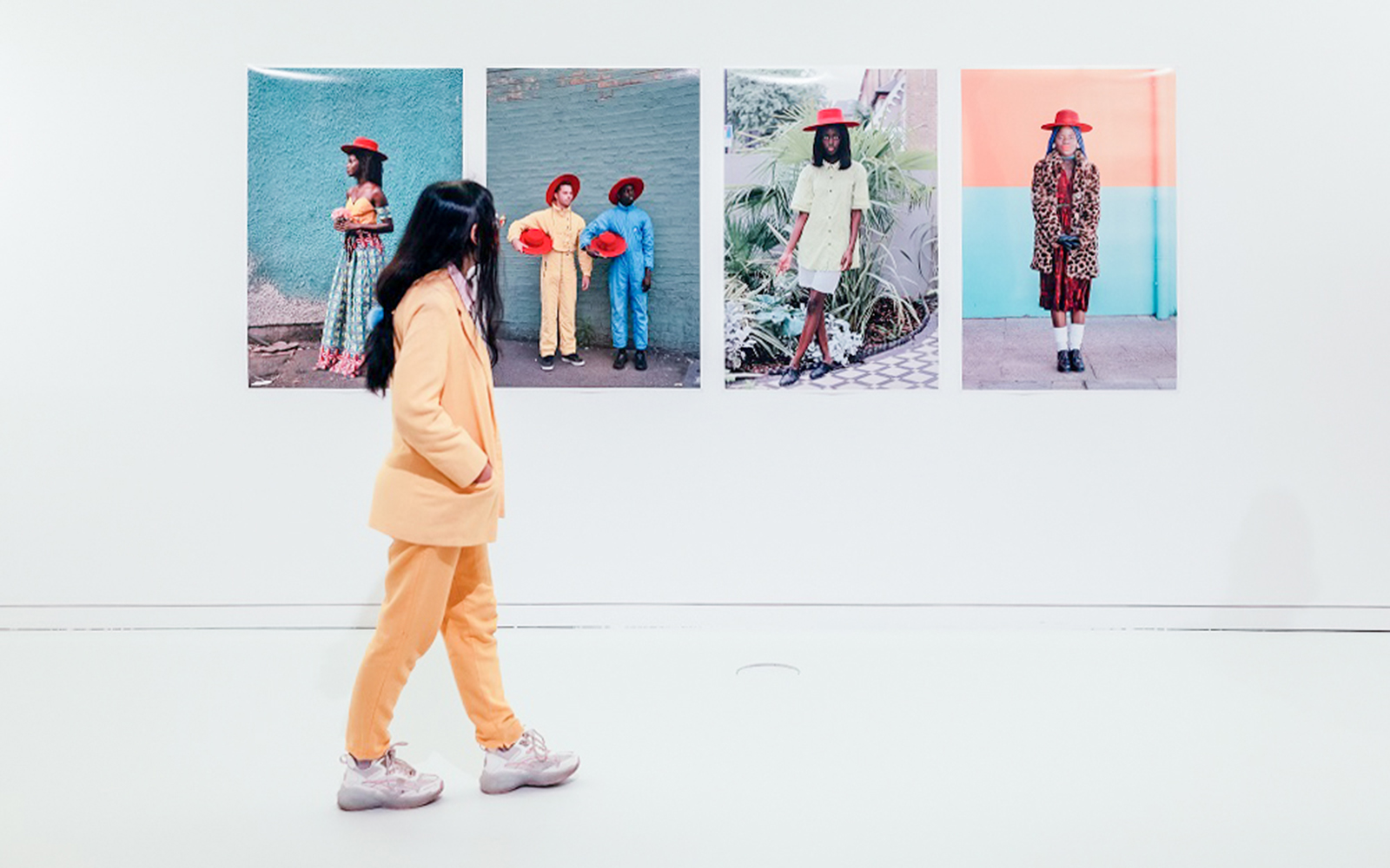 Visitor viewing colorful portraits at MAAT Gallery, Lisbon.