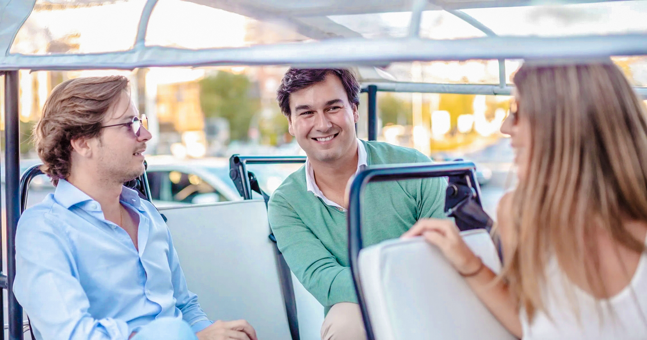 Passengers enjoying eco tuk tuk tour in Madrid.