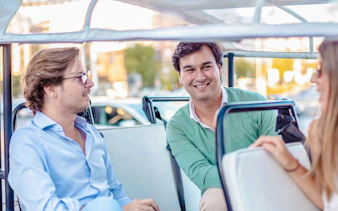 Passengers enjoying eco tuk tuk tour in Madrid.