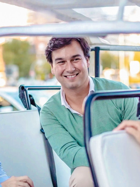 Passengers enjoying eco tuk tuk tour in Madrid.