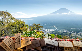 View of Mount Fuji from Tenjo Yama Park with wooden prayer plaques in foreground.