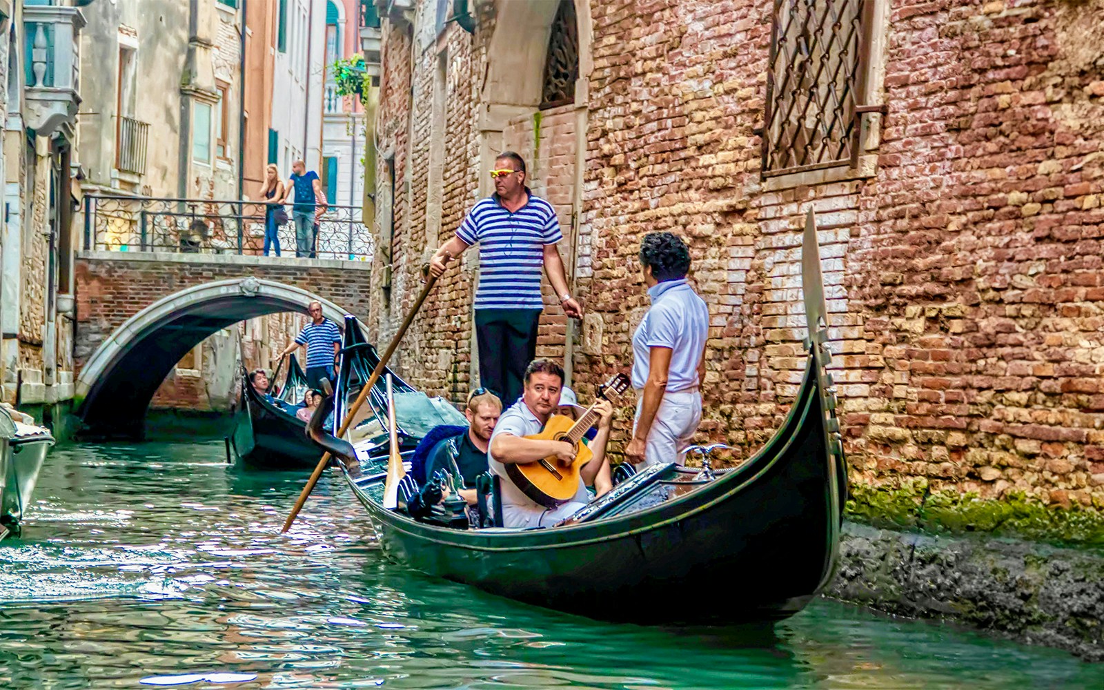 Gondola ride with musician serenading in Venice canal.