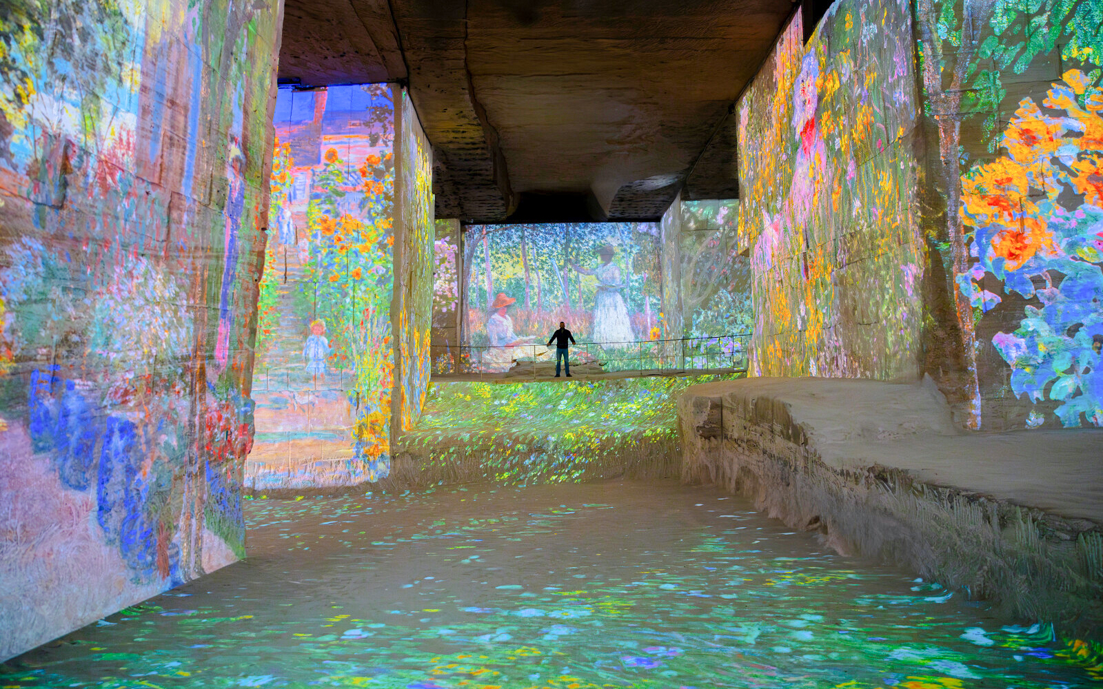 Monet's artwork projected on walls at Carrières des Lumières, France.