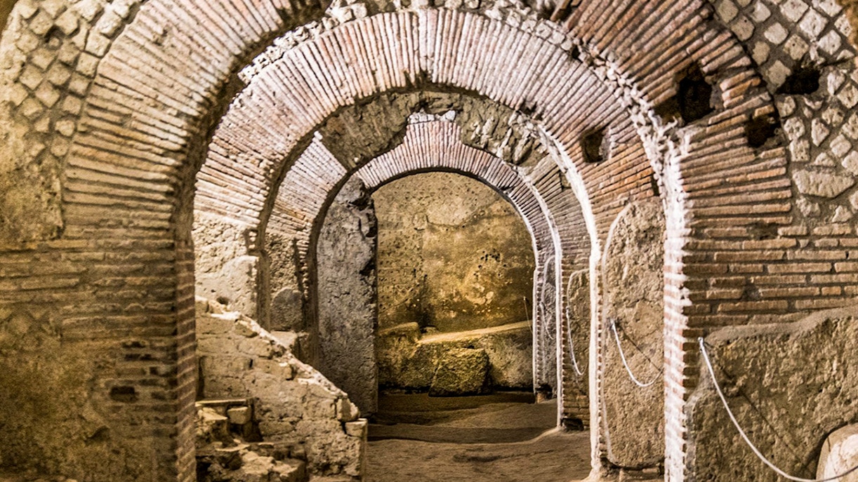 Neapolis Sotterrata with tourists exploring underground ruins on a guided tour.