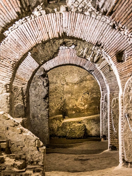 Underground ruins with ancient brick arches in Naples city tour.