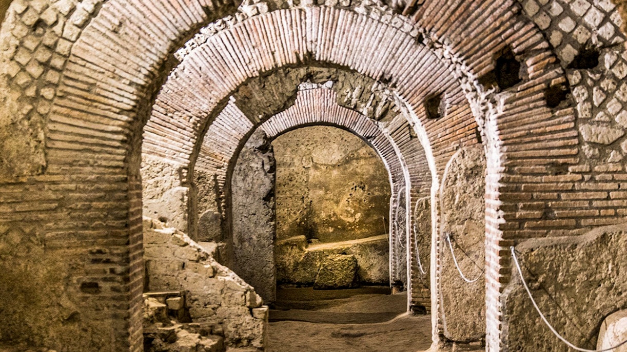 Neapolis Sotterrata with tourists exploring underground ruins on a guided tour.