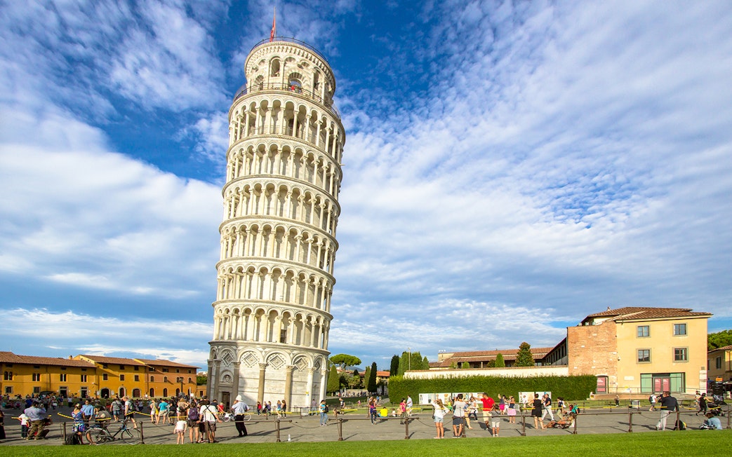 Leaning Tower of Pisa with tourists in Piazza dei Miracoli, Italy.