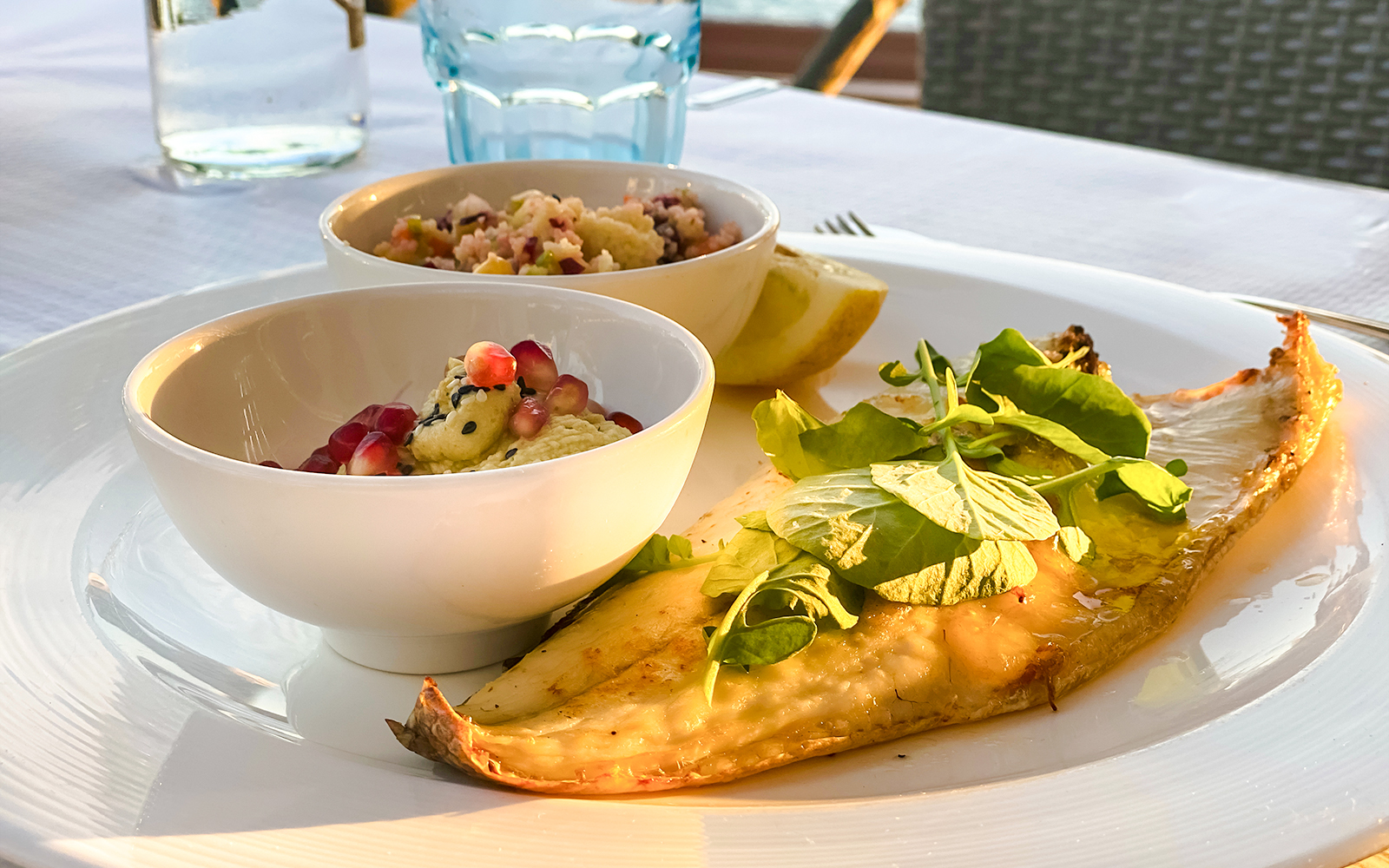Grilled turbot with greens and side dishes at Montjuïc restaurant.