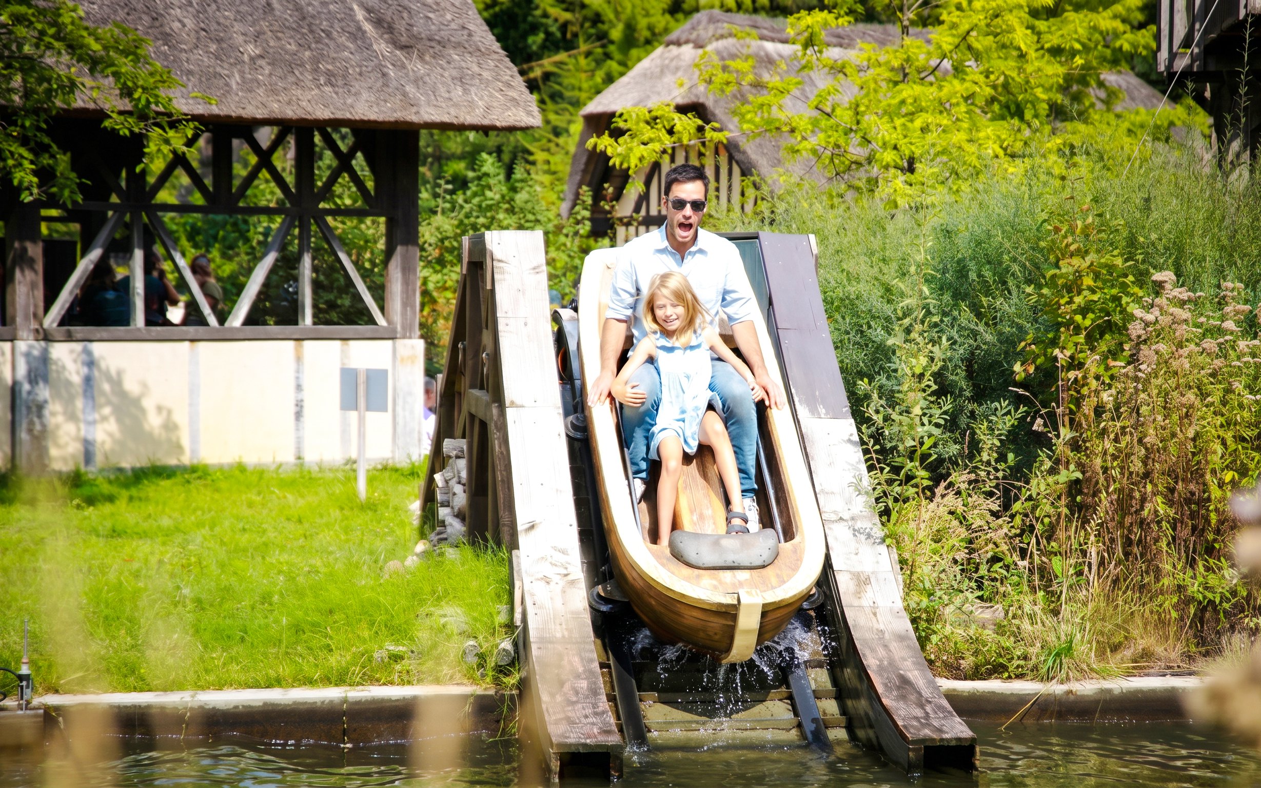 Father and daughter on log flume ride at Jardin d'Acclimatation, Paris.