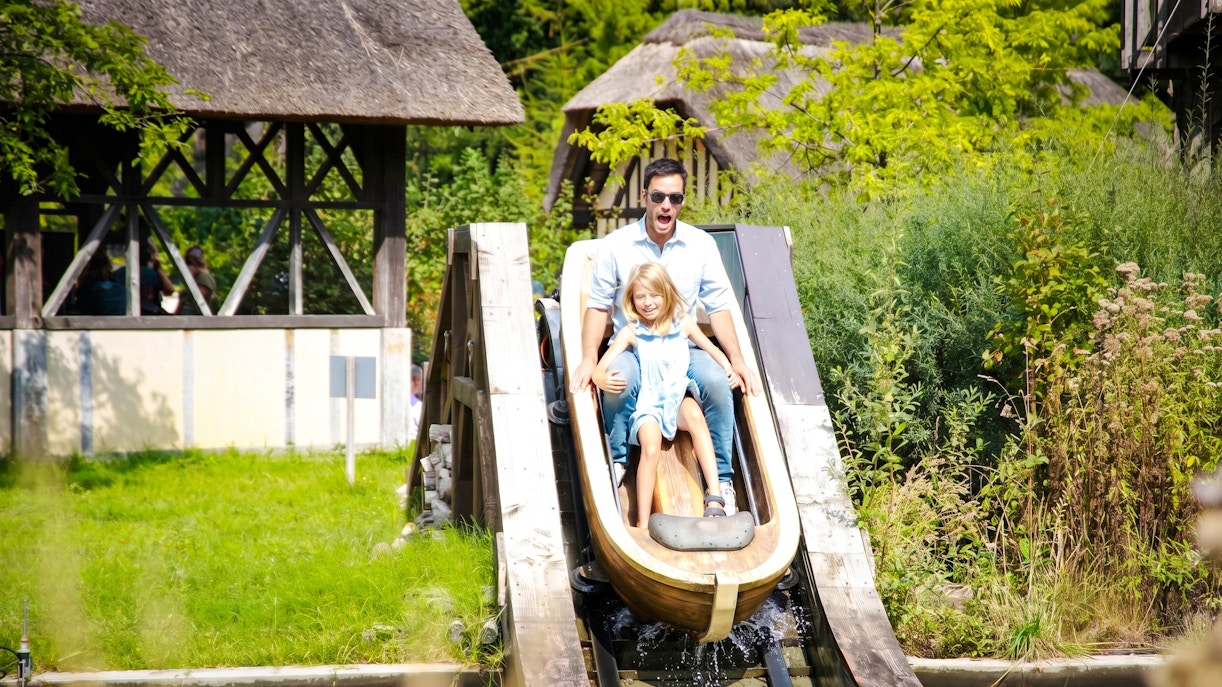 Father and daughter on log flume ride at Jardin d'Acclimatation, Paris.