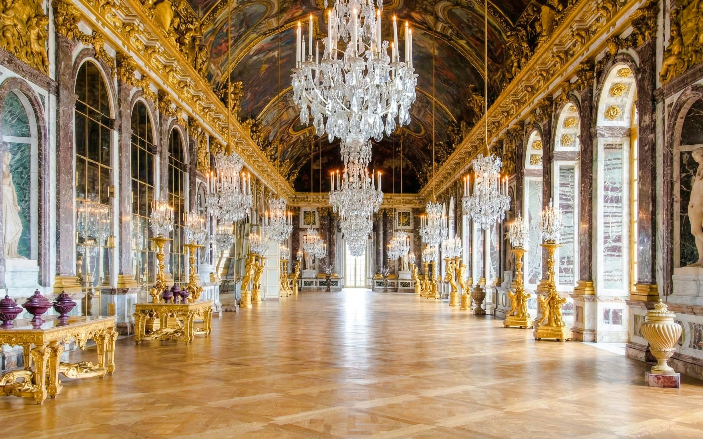 Hall of Mirrors with chandeliers and ornate decor, Palace of Versailles, France.