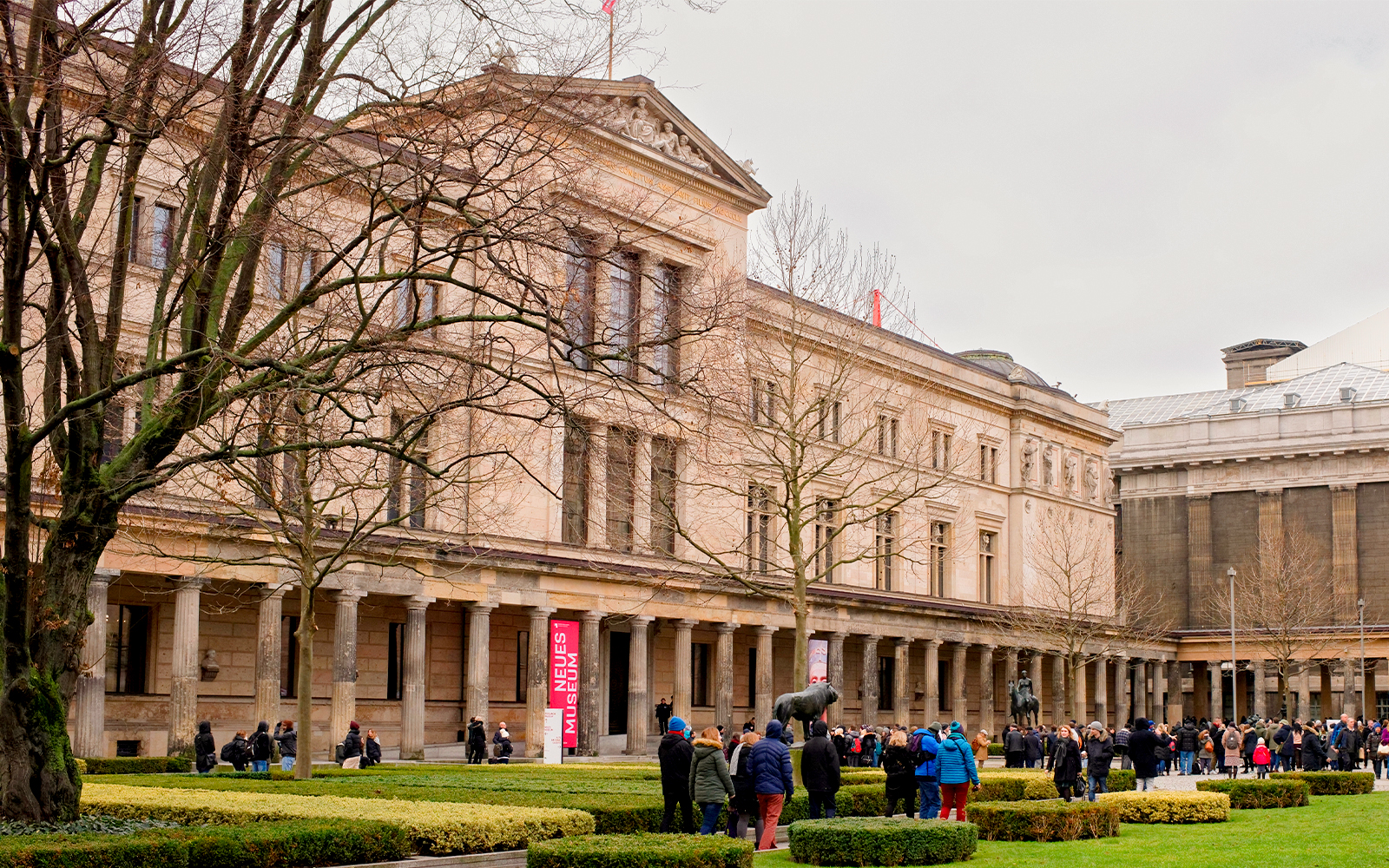 Neues Museum Berlin exterior with visitors in front of the entrance.