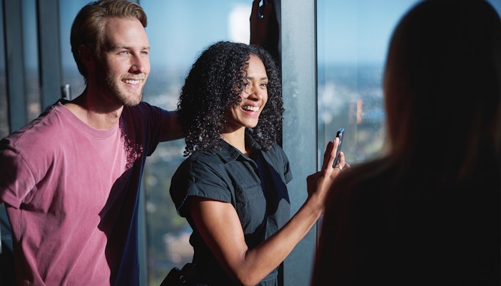 Visitors enjoying the view from Melbourne Skydeck during the Ultimate Skydeck Experience.