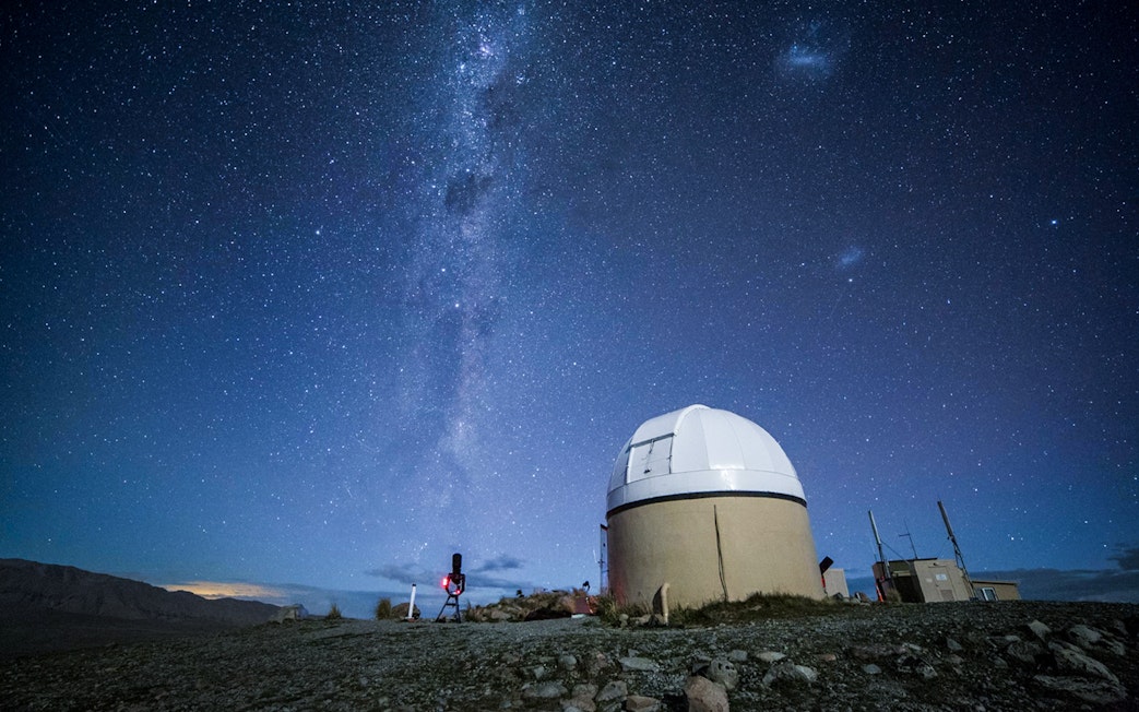 Mt. John Observatory under starry sky during stargazing experience in New Zealand.