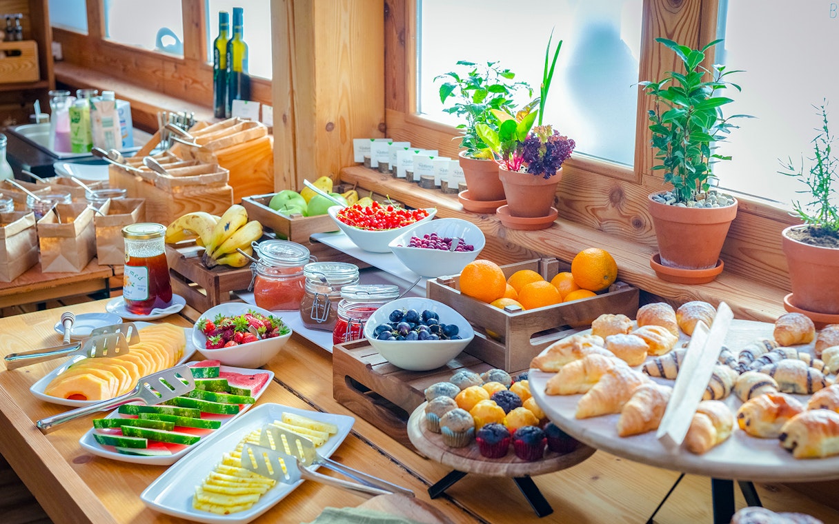 Breakfast buffet with tropical fruits and pastries at Bali Zoo, Indonesia.