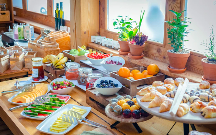 Breakfast buffet with tropical fruits and pastries at Bali Zoo, Indonesia.
