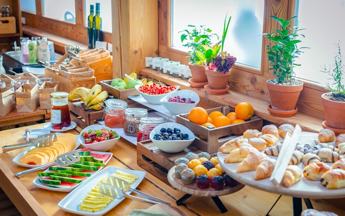 Breakfast buffet with tropical fruits and pastries at Bali Zoo, Indonesia.