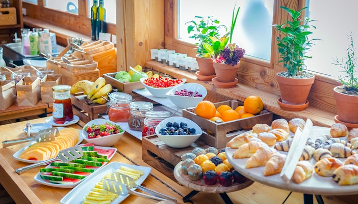 Breakfast buffet with tropical fruits and pastries