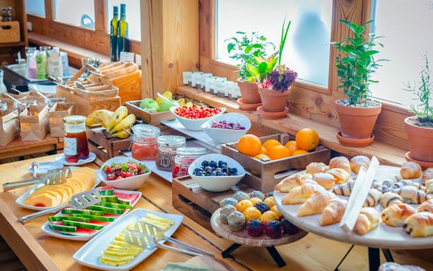 Breakfast buffet with tropical fruits and pastries at Bali Zoo, Indonesia.