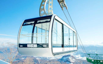 Cable car ascending Mt. Usu with snowy landscape, Hokkaido.