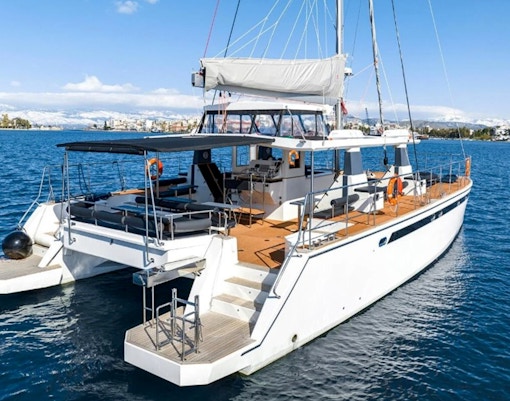Catamaran on Santorini Caldera cruise with seating and sunshade.