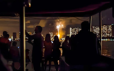 Guests watching fireworks over Waikiki skyline, Honolulu, Hawaii.