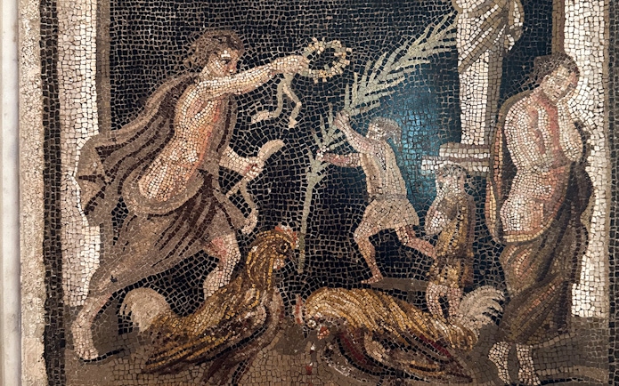 Ancient mosaic depicting figures and roosters at Naples National Archaeological Museum.