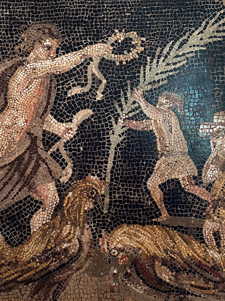 Ancient mosaic depicting figures and roosters at Naples National Archaeological Museum.