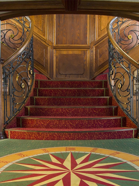 Elegant staircase on Budapest Danube River evening cruise ship interior.