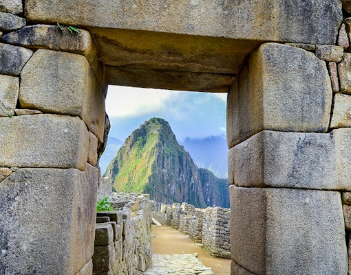 Main entrance doorway at Machu Picchu with stone steps and ancient Incan architecture.