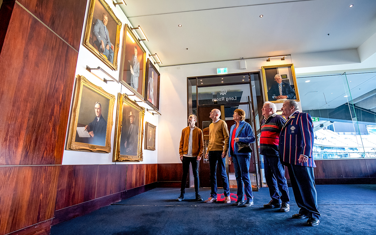 Visitors admiring portraits in the Long Room during the MCG tour in Melbourne.