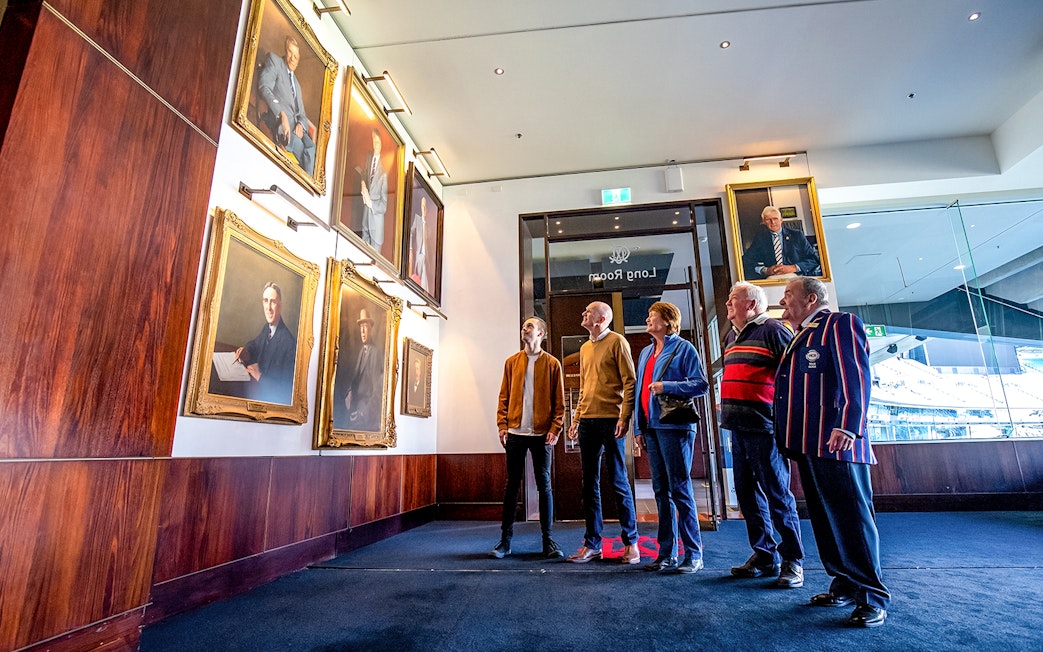 Visitors admiring portraits in the Long Room during the MCG tour in Melbourne.