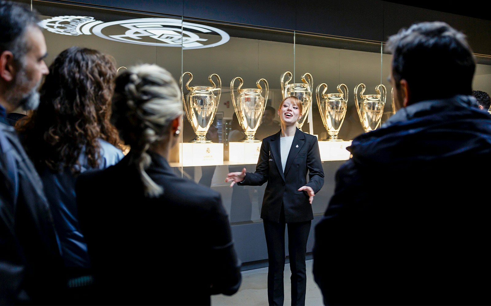 Guide explaining trophies at Santiago Bernabéu Stadium tour.