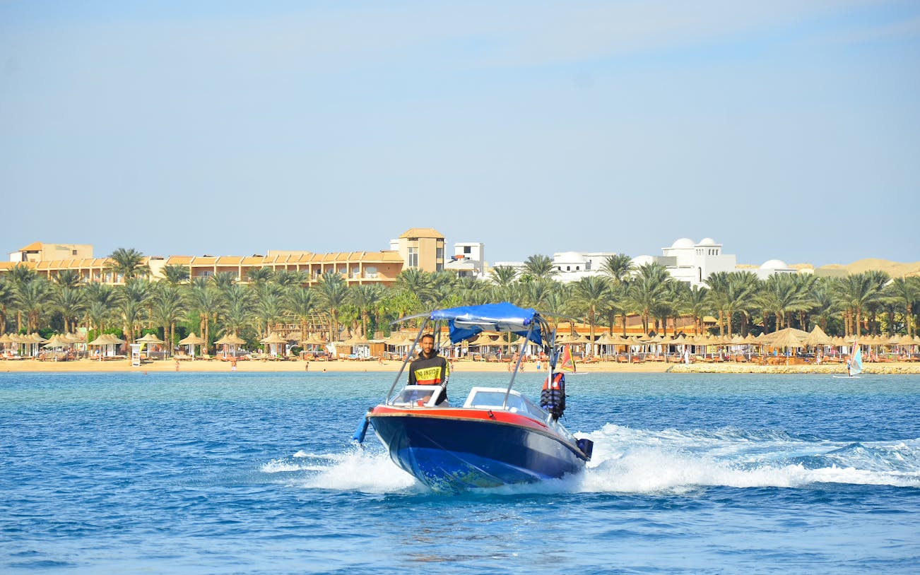 Private speedboat on the water near a beach resort, heading to Dolphin House.