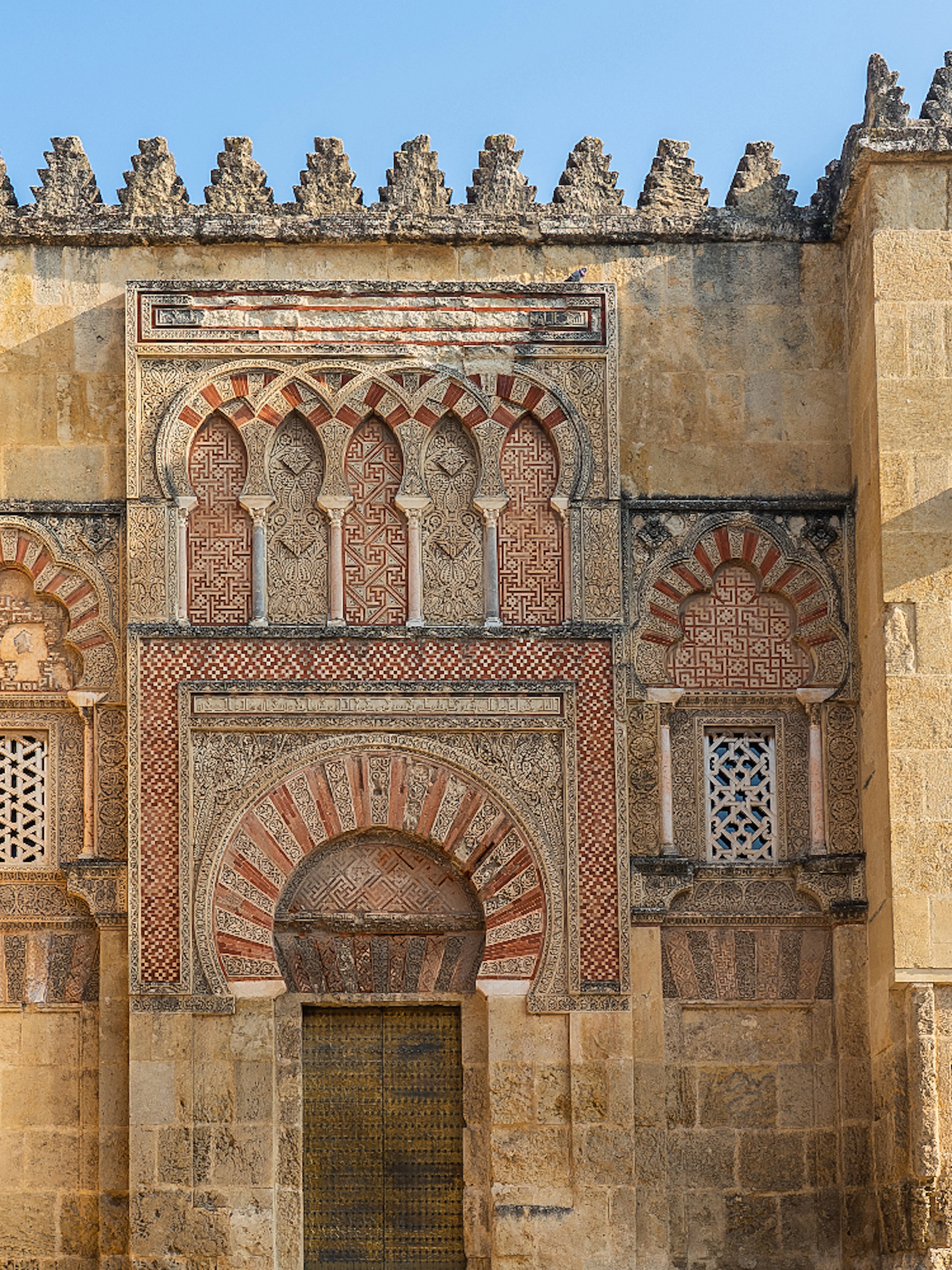 Mosque Cathedral of Cordoba ornate exterior wall with arches and intricate stonework.