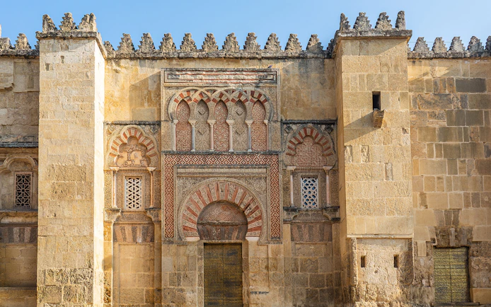 Mosque Cathedral of Cordoba ornate exterior wall with arches and intricate stonework.