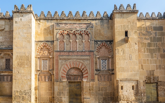Mosque Cathedral of Cordoba ornate exterior wall with arches and intricate stonework.