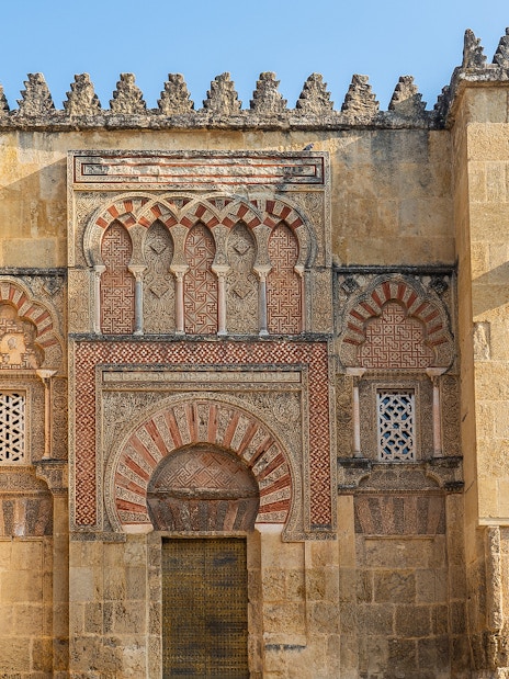 Mosque Cathedral of Cordoba ornate exterior wall with arches and intricate stonework.