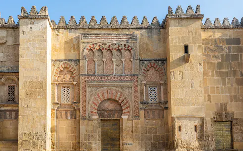 Mosque Cathedral of Cordoba ornate exterior wall with arches and intricate stonework.