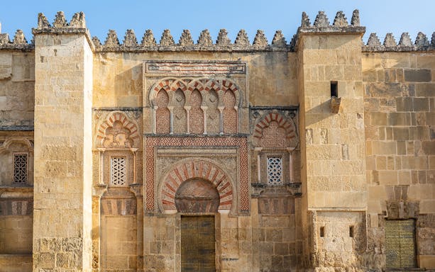 Mosque Cathedral of Cordoba ornate exterior wall with arches and intricate stonework.