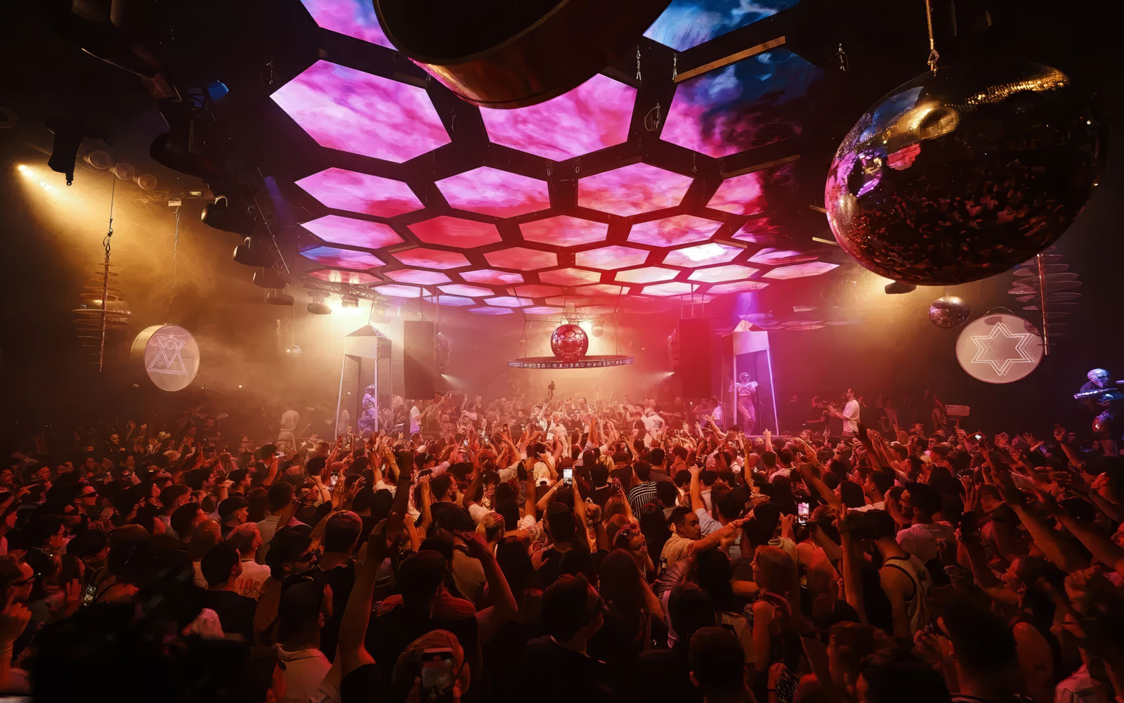 DJ performing at Music On event, Pacha Ibiza nightclub, with vibrant crowd and lighting.