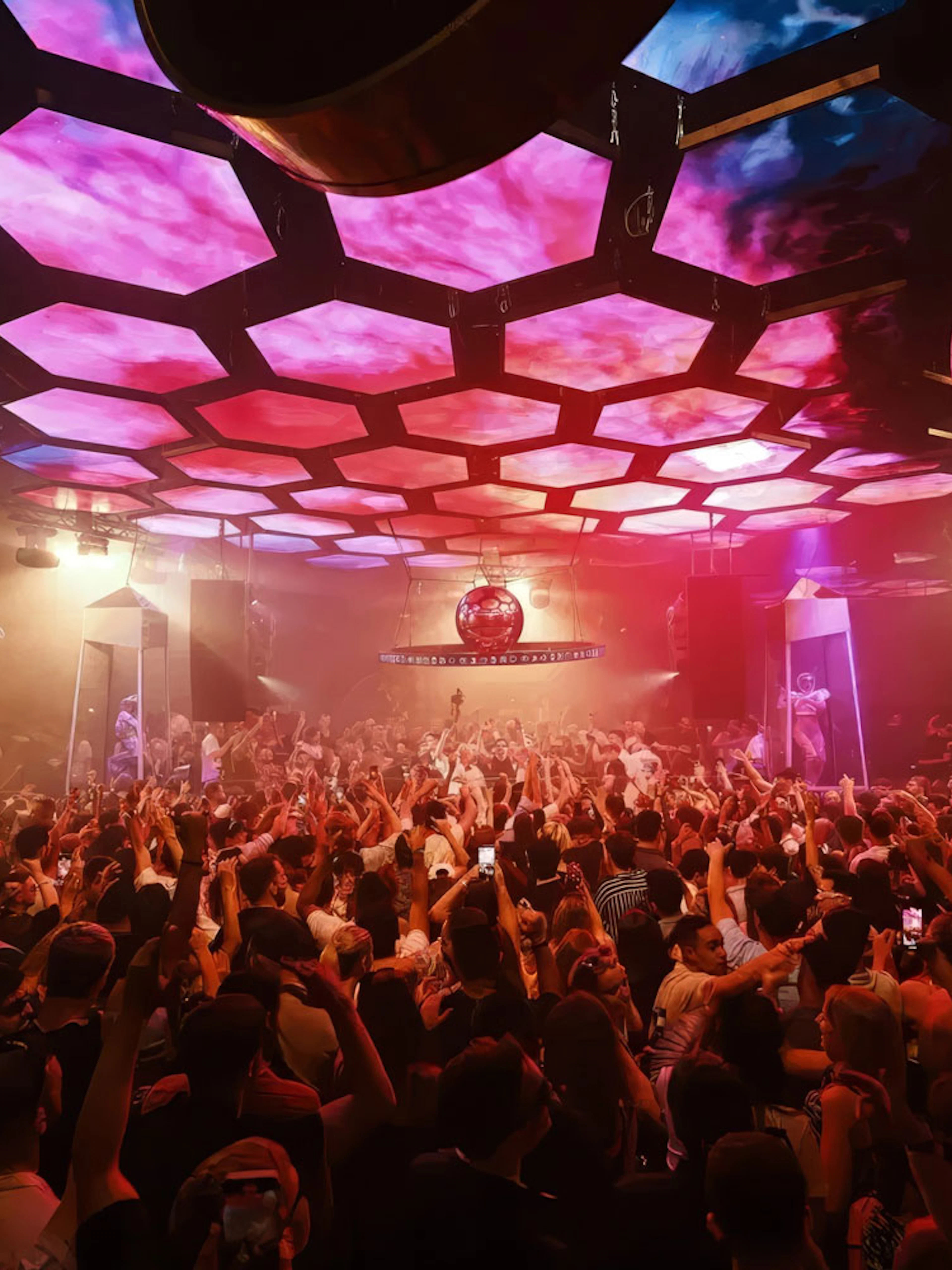 DJ performing at Music On event, Pacha Ibiza nightclub, with vibrant crowd and lighting.