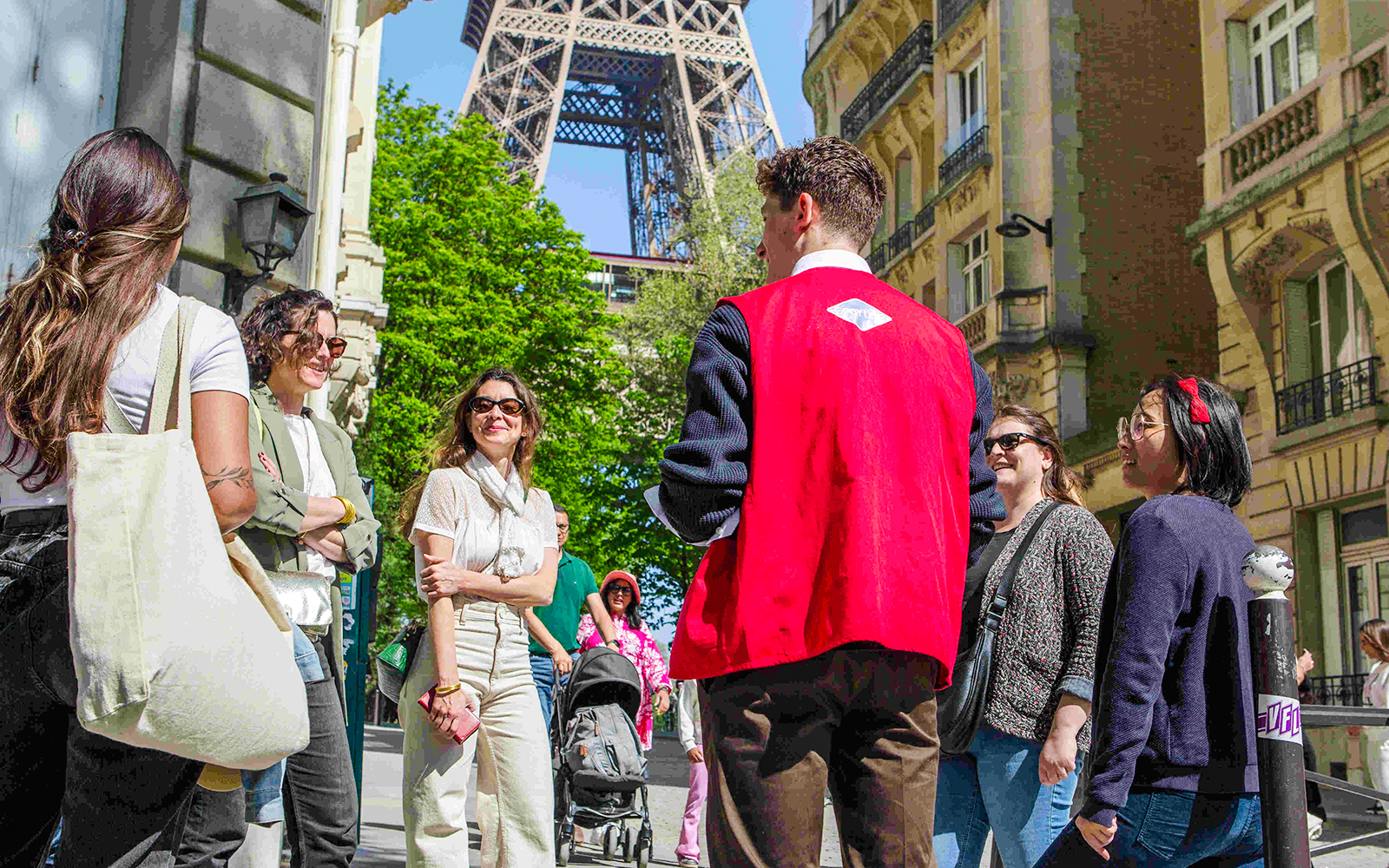 Group with guide on Paris Illumination Tour near Eiffel Tower.