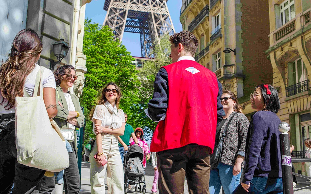 Group with guide on Paris Illumination Tour near Eiffel Tower.