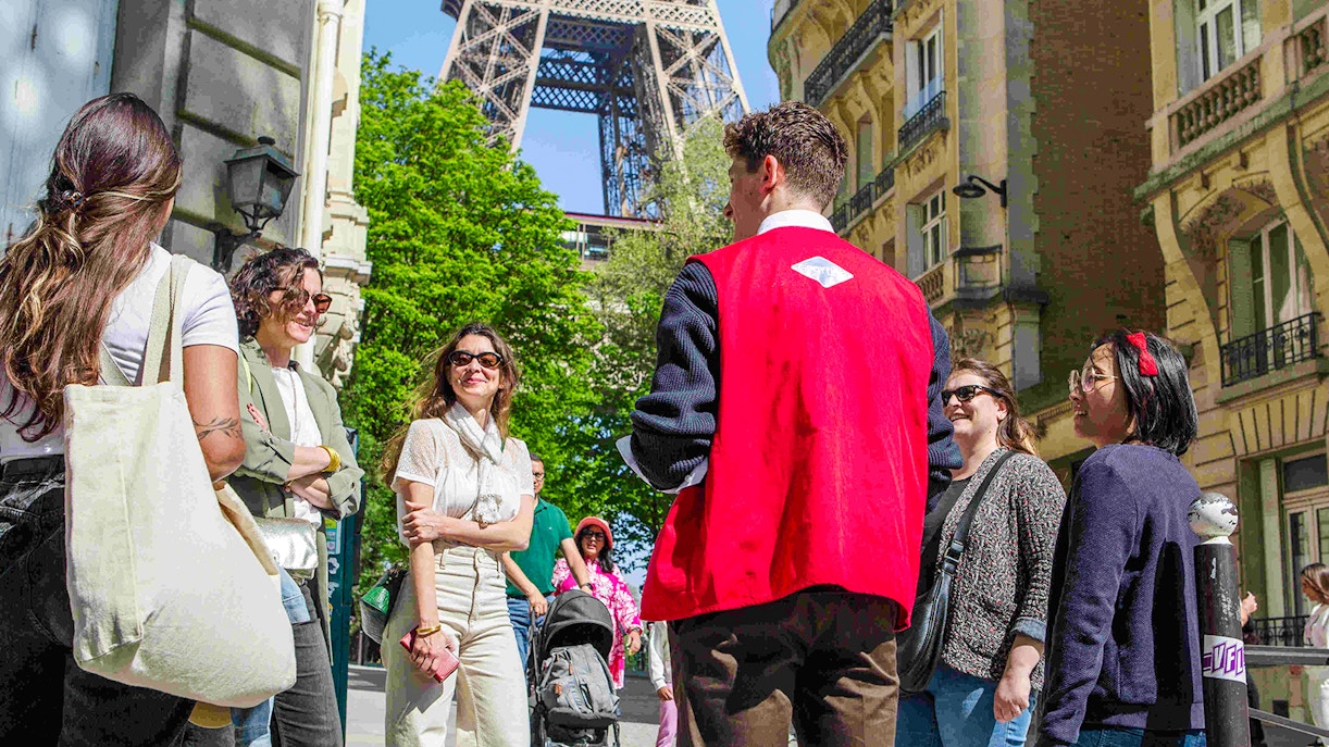Group with guide on Paris Illumination Tour near Eiffel Tower.