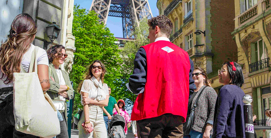 Group with guide on Paris Illumination Tour near Eiffel Tower.