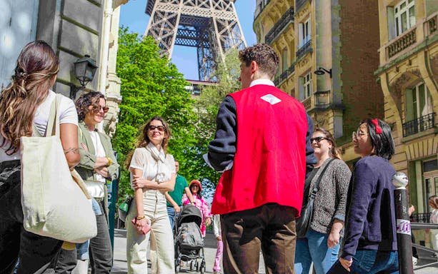 Group with guide on Paris Illumination Tour near Eiffel Tower.