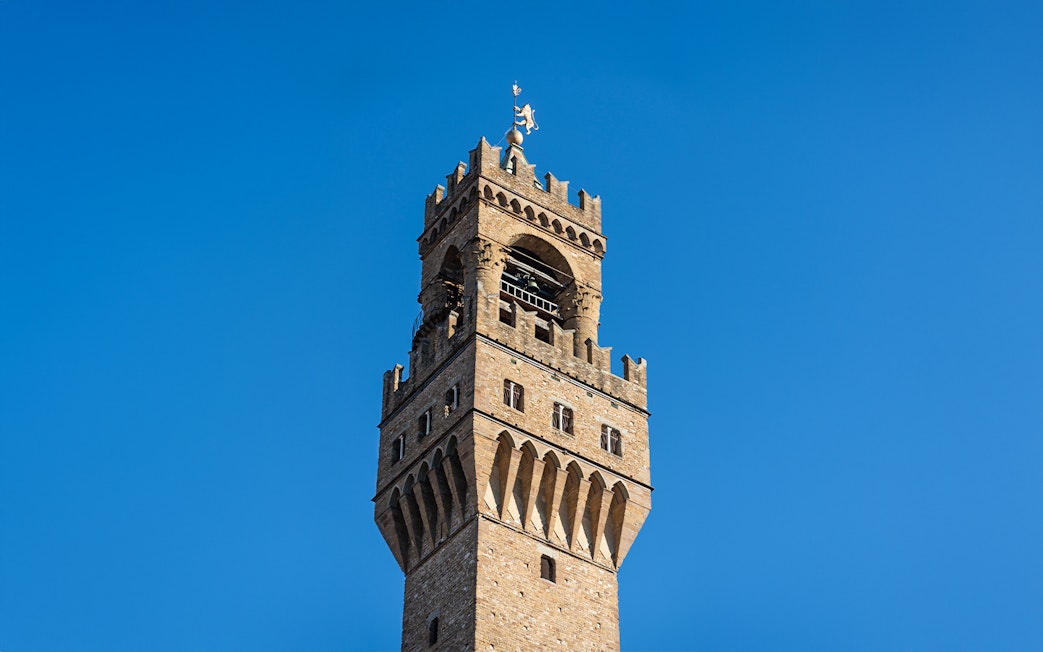 Arnolfo Tower against a clear blue sky in Florence, Italy.