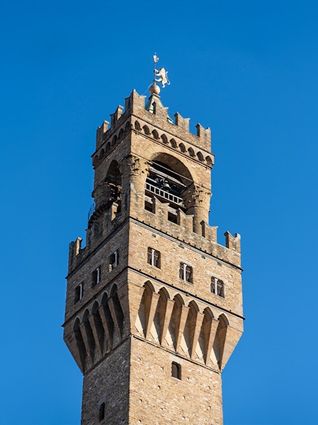 Arnolfo Tower against a clear blue sky in Florence, Italy.