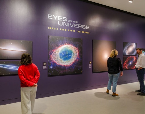 Visitors exploring the Eyes on the Universe exhibit at the American Museum of Natural History.